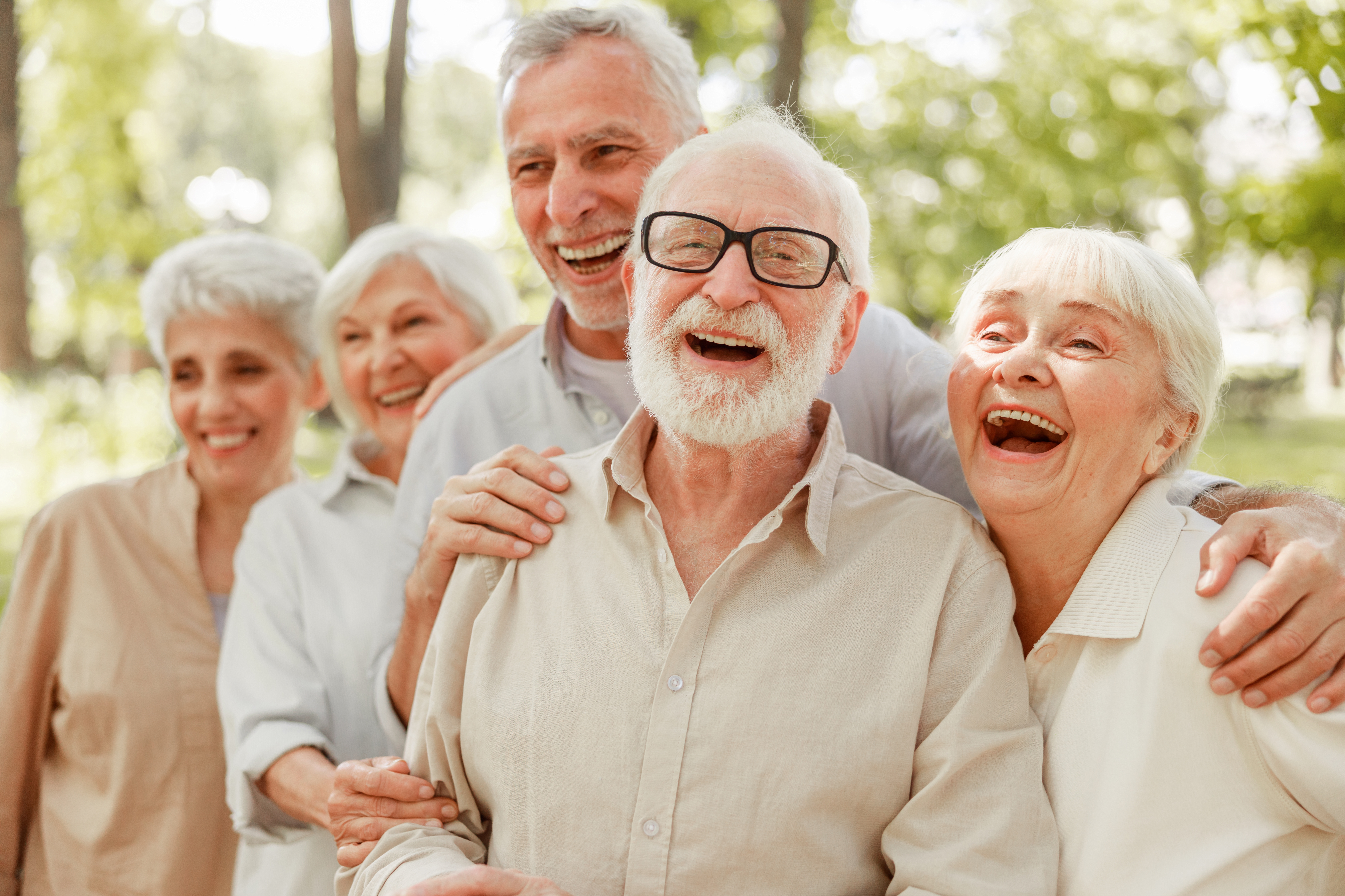 A group of happy senior friends laughing outdoors